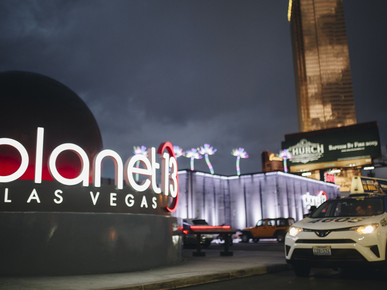 Planet 13 Las Vegas exterior at night with its illuminated globe sign